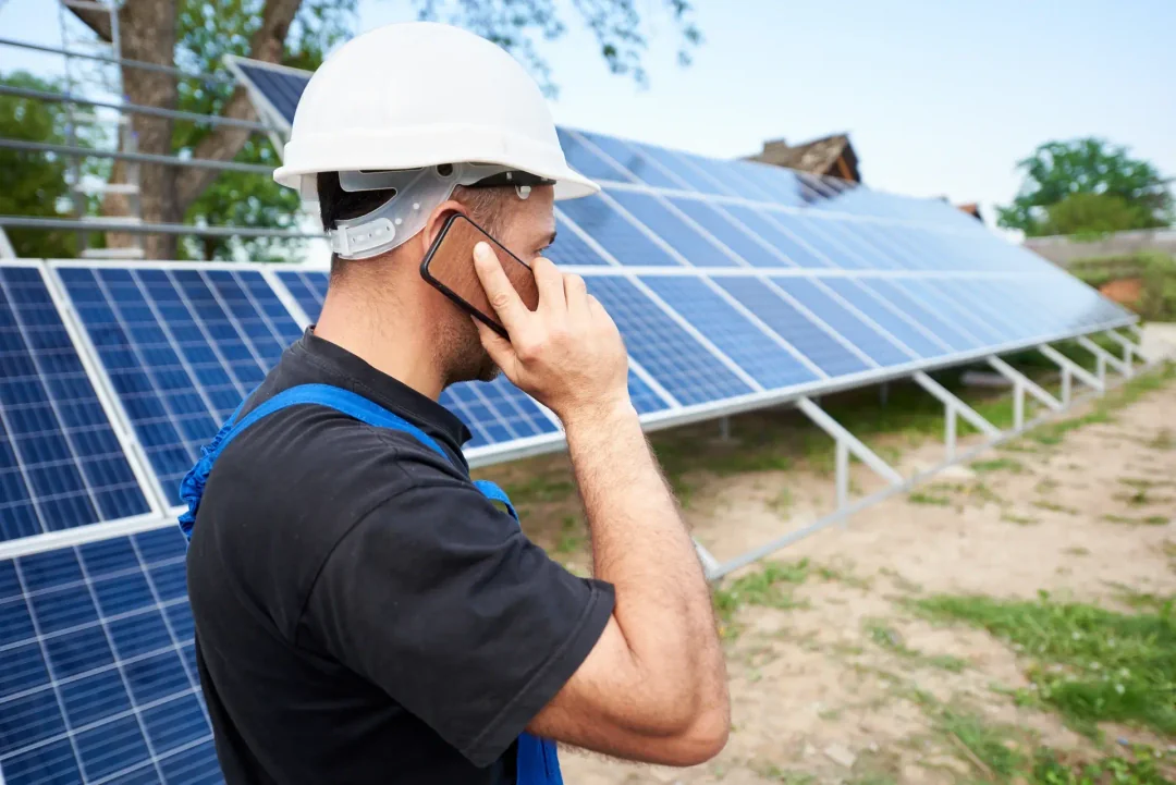 Professional man talking on the phone in a solar powered field.